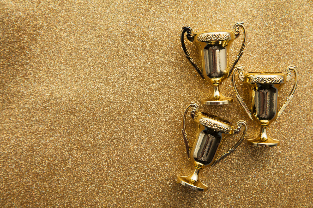 Trophies on a Gold Glitter Background